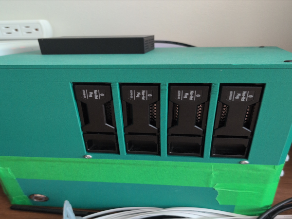 A photograph of a green 3D printed shell for a server.